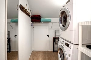 Your dedicated laundry room features a convenient stacked washer and dryer with ample storage space for all your vacation essentials.