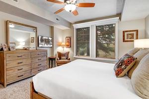 Sink into crisp linens and enjoy your favorite shows from the comfort of a plush bed, cooled by a gentle overhead fan and framed by peaceful mountain views through large windows.