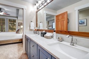 Freshen up at your private dualsink vanity with crisp white counters and soft linens ready. The spacious mirror and bright lighting make morning routines feel effortless and relaxed.