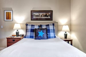Sink into crisp white linens and plush pillows after a day of adventure. Your inviting bedroom features warm bedside lighting and thoughtful décor for a restful retreat.