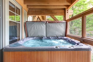 Soak in your own private hot tub on the covered deck, surrounded by lush forest views and peaceful natural beauty.