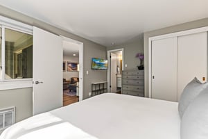 King bedroom with TV, dresser, closet, ensuite bathroom and direct access to the living area