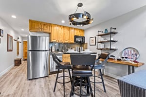 The open concept dining and kitchen area with some open shelving on the adjacent wall.