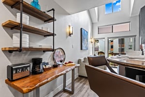 The live edge wood table with a coffee bar.