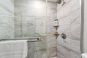 The bathroom with a bathtub and shower combination.