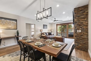 Open dining area with wood table, seating for six and views into the adjoining living room.
