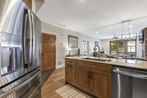 The wellequipped kitchen has beautiful wood cabinets and stainless steel appliances.