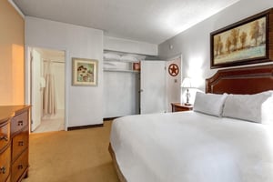 Queen bedroom with bedside lighting, closet storage and direct access to the adjoining bathroom.