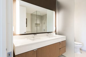 Main bathroom with double vanity, white quartz countertops.