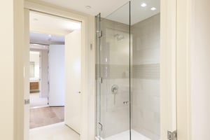 34 hallway bathroom tiled shower with glass door.