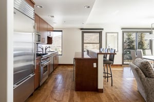 Fully equipped kitchen with kitchen island and hardwood floors throughout.