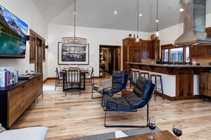 Two comfortable leather chairs in the open concept living area.