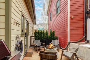 The heated patio offers a hot tub, fire table with seating for four, and BBQ gas grill.