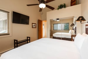Wall mounted TV in the main bedroom