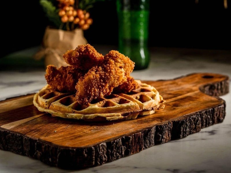 Chicken  waffles drizzled with maple syrup