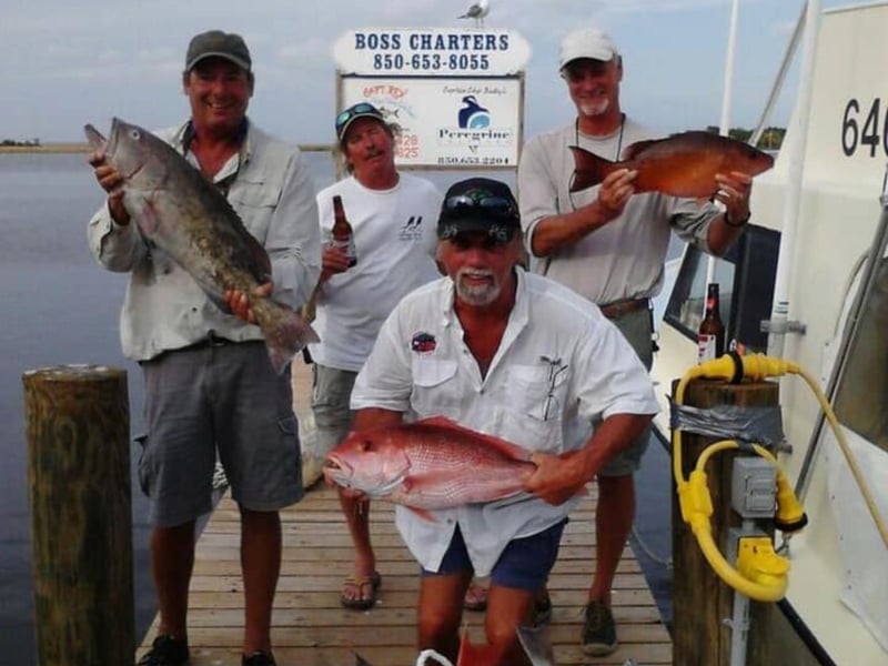 A group on the dock showing off their catches