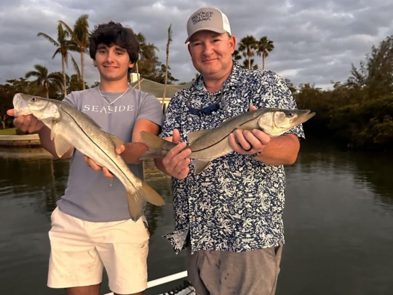 A group on the dock with their fish in Bradenton Beach, Florida