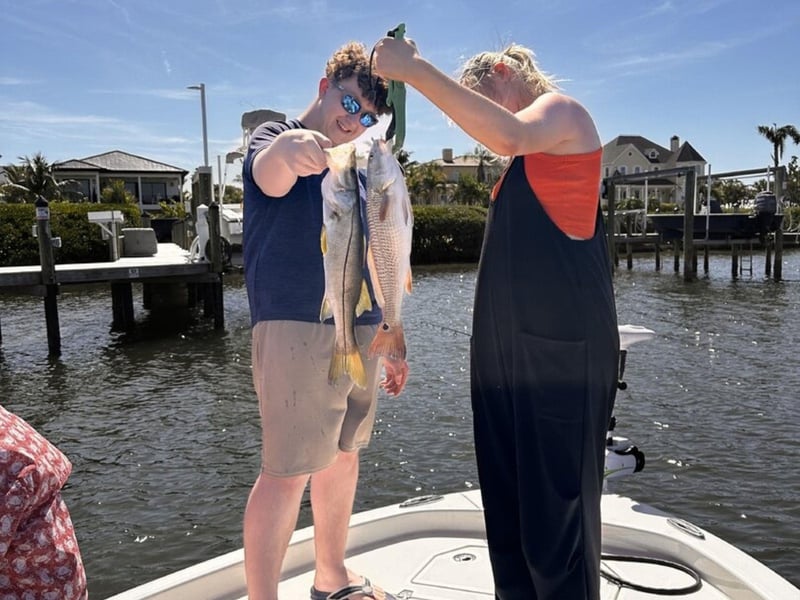 A group showing off their catches on the boat