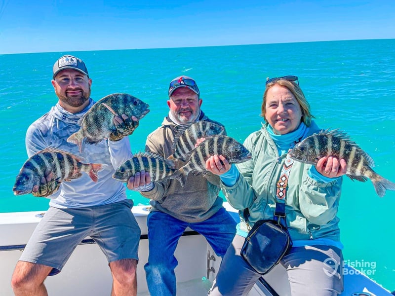 Anglers showing off their fish on the boat