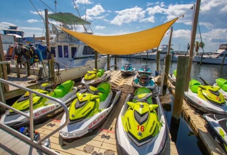 multiple jet skis lined up at a dock in Gulf Shores, Alabama