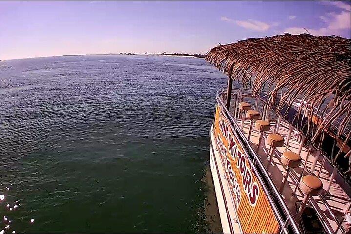 Island Tiki Tours boat cruising clear water near Shell Island