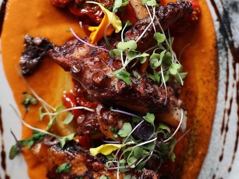 Spanish octopus with red pepper hummus