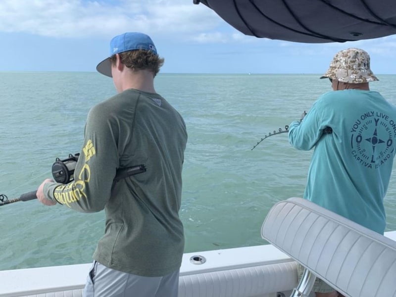 Two anglers fishing with Reel Thrills Fishing Charters