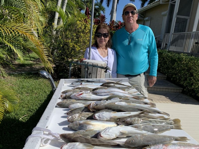Two guests on the dock with their fish in Marco Island, Florida