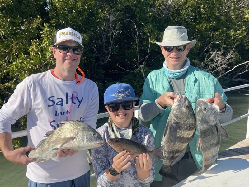A family showing off their catches