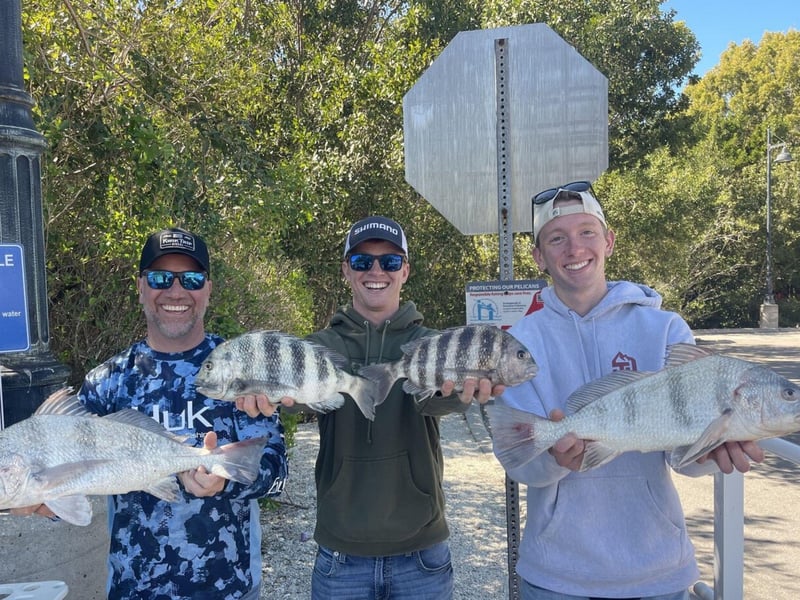 A group on the dock showing off their catches