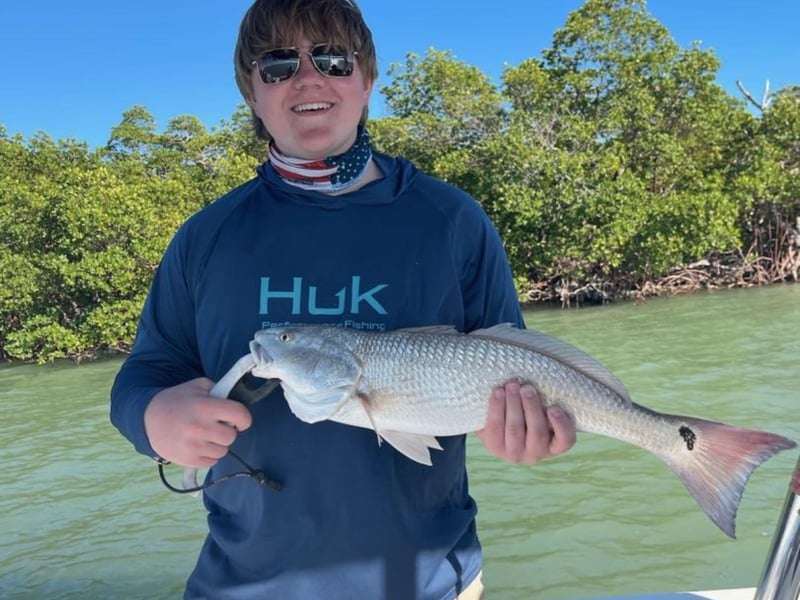 An angler with his catch from Skinny Dipn Charters