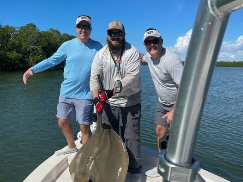 Anglers with a sting ray from Red Snarpon Charters Inc.