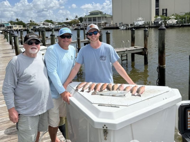 A group with their catches on the dock in Marco Island, Florida
