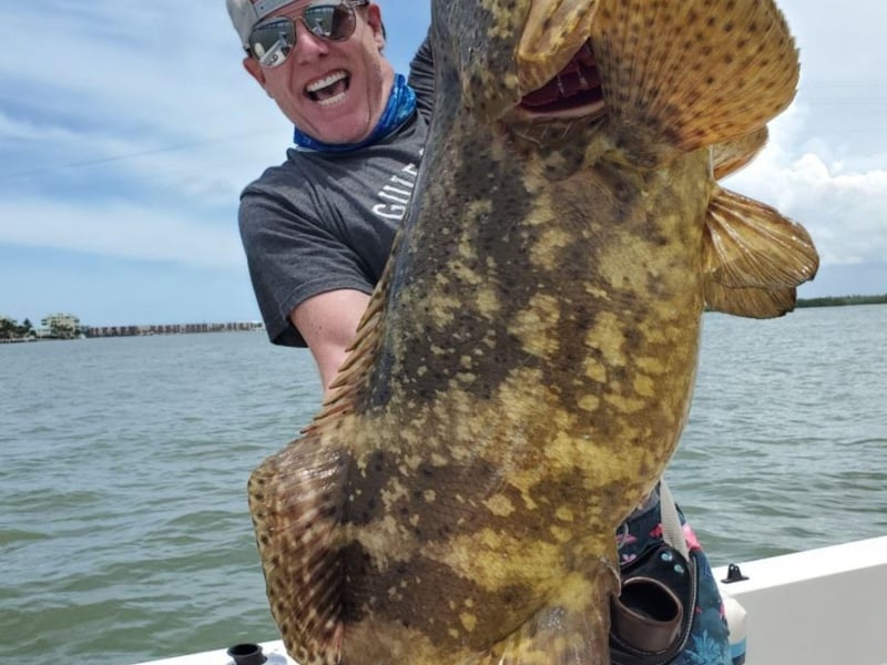 An angler showing off his giant catch
