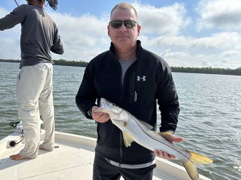 A guest with his catch on the boat