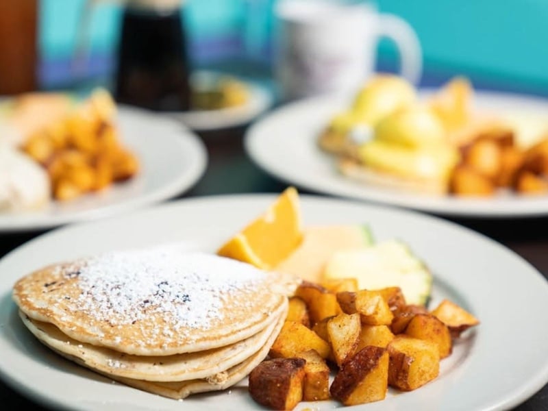 Fresh pancakes with potatoes and fruit