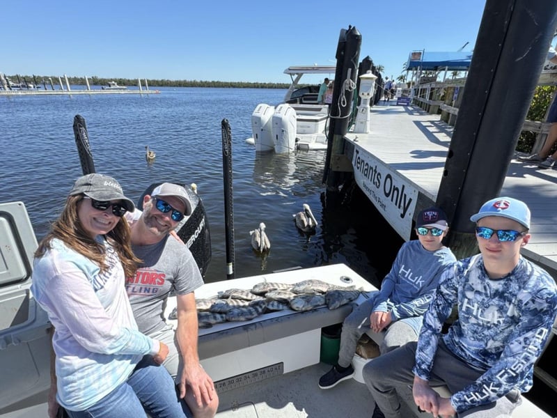 A family wA family on the dock in Sanibel, floridaith their fish on the dock