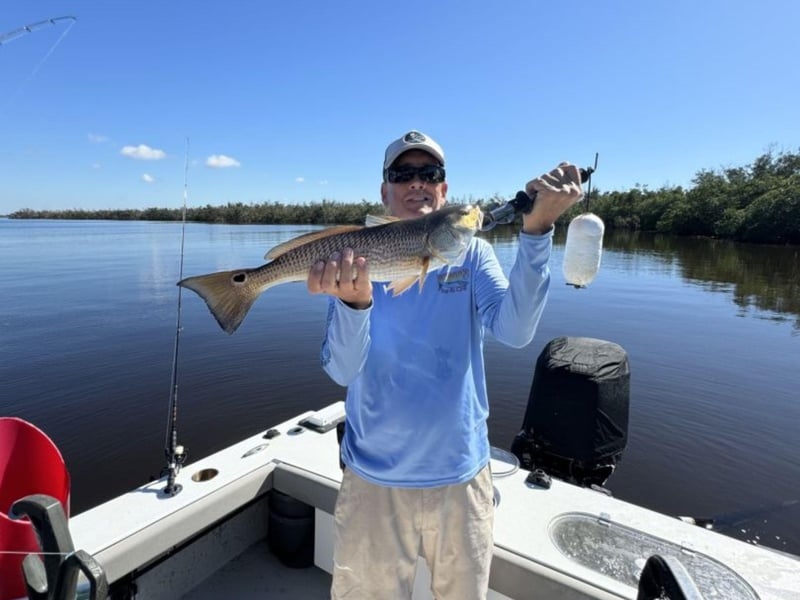 An angler showing off his catch with Spangler Adventures