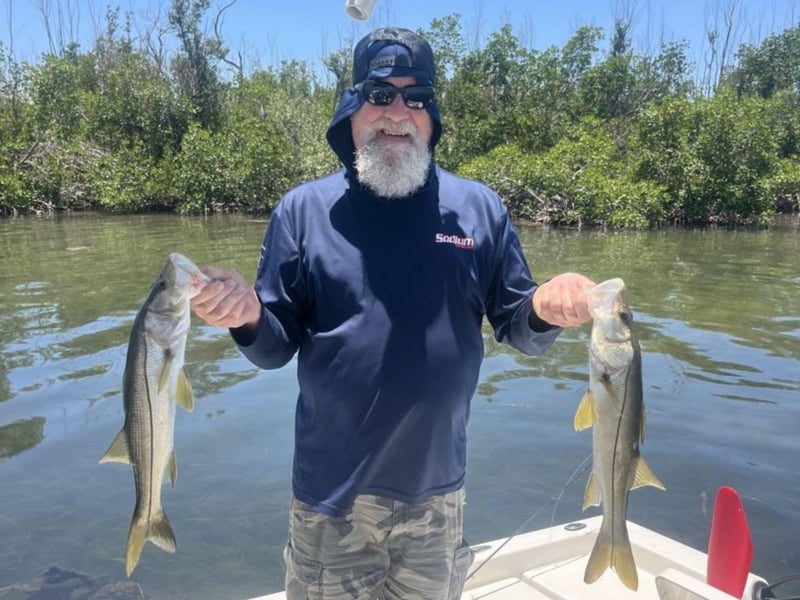 A guest with his two fish on the boat