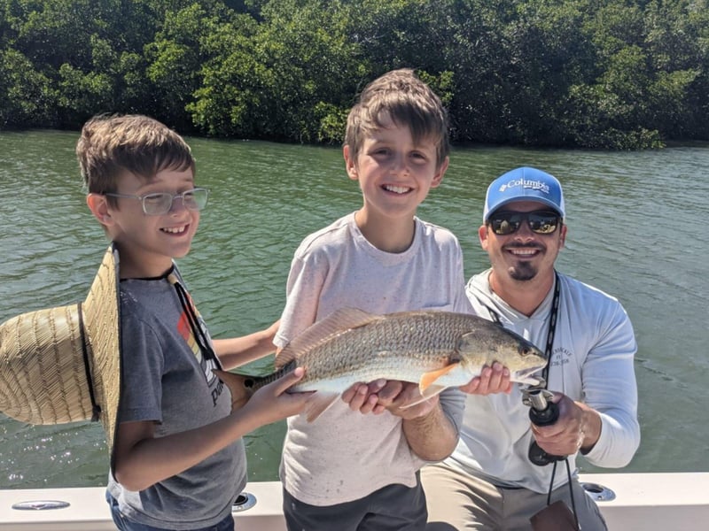 A family showing off their fish on the boat