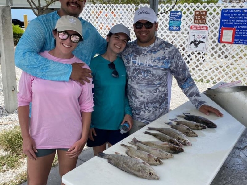 A family with thier fish at the dock