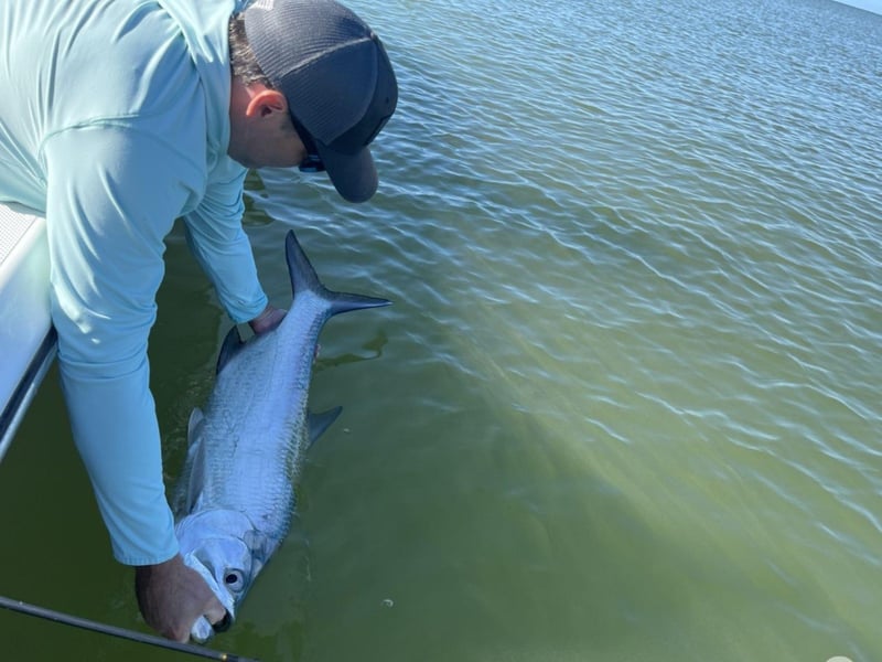 A guest fishing off the side of the boat