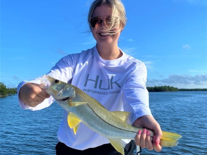 An angler showing off her catch
