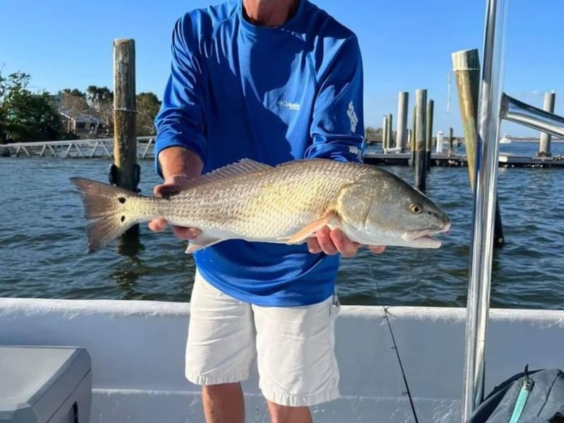 A guest with his catch on the boat