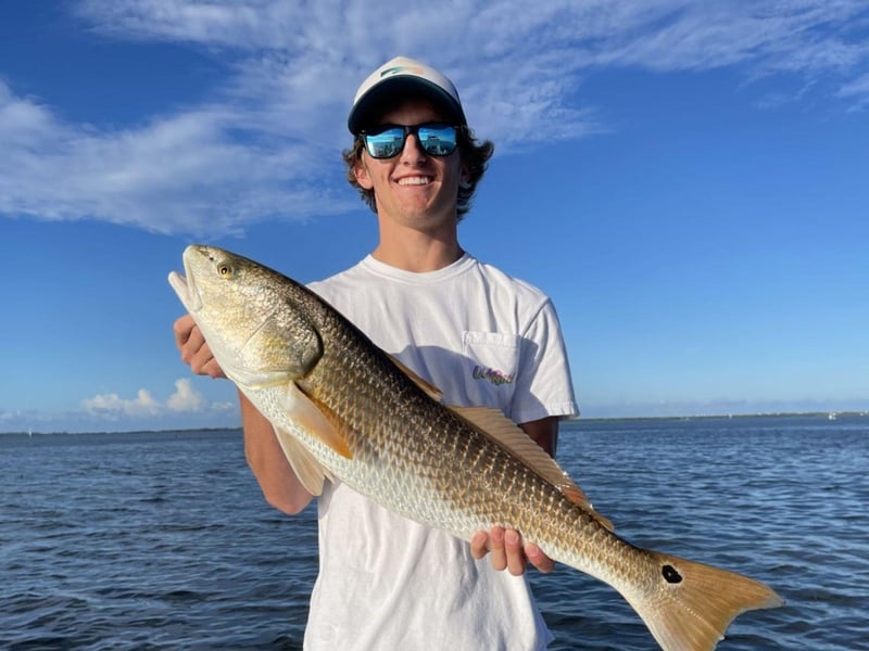 A guest with his catch on the boat