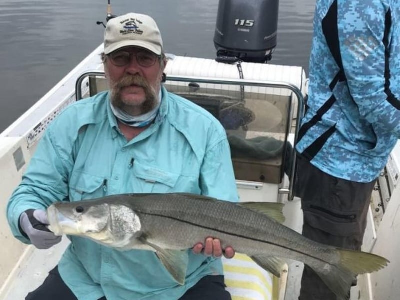 A guest showing off his catch on the boat
