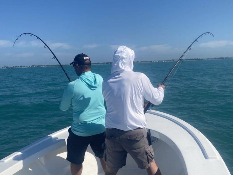 Two anglers fishing off the boat