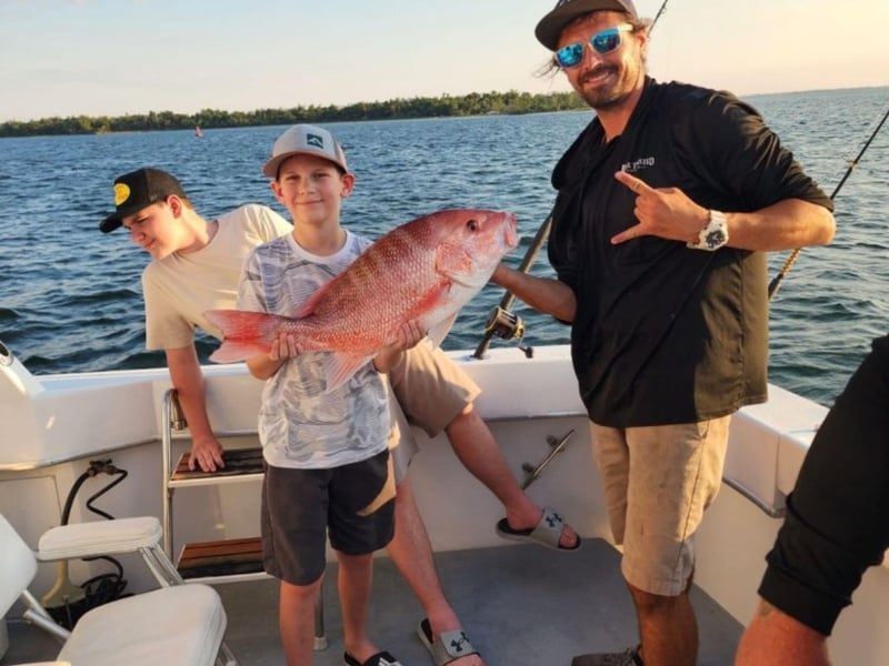 A family showing off their catch with Unorthadox Charters