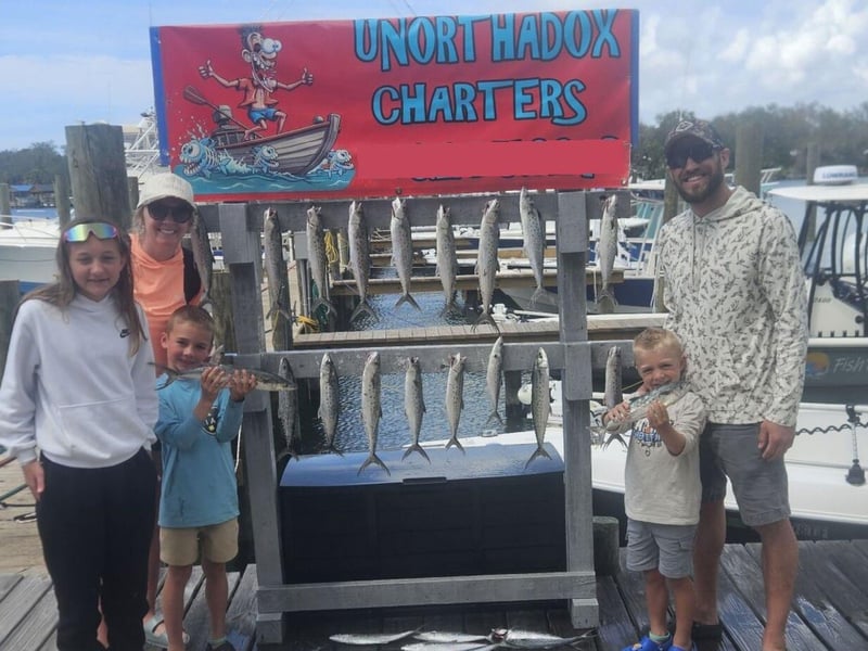 A family on the dock with their catches in Panama City Beach, Florida