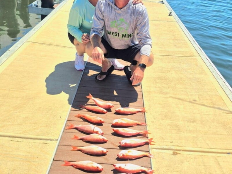 A group at the marina showing off their fish